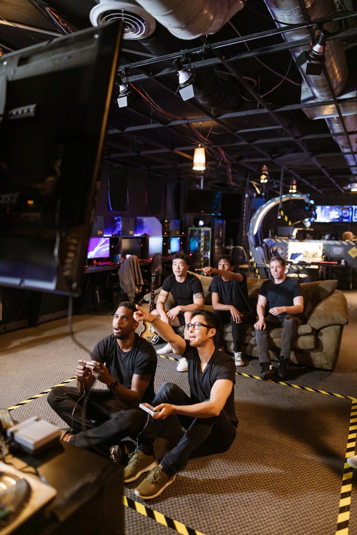 A diverse group of friends playing video games in a modern arcade setting.